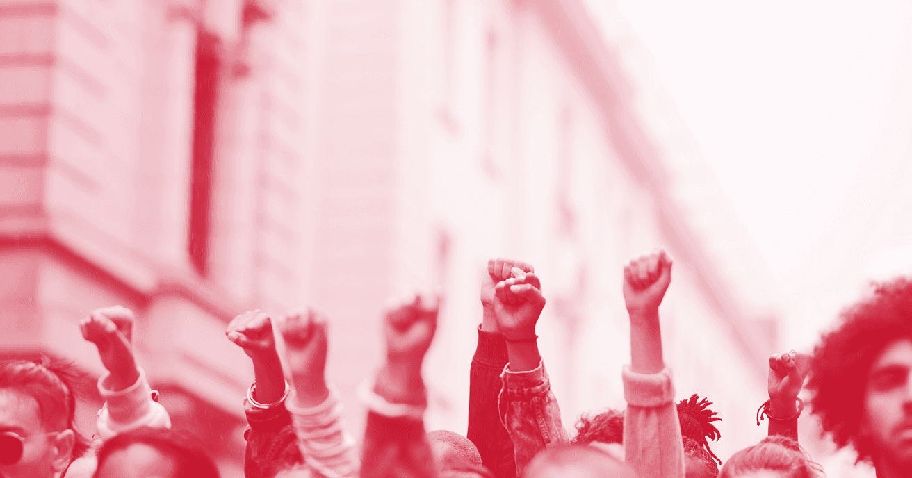 A red and white photo of a number of fists raised in the air.